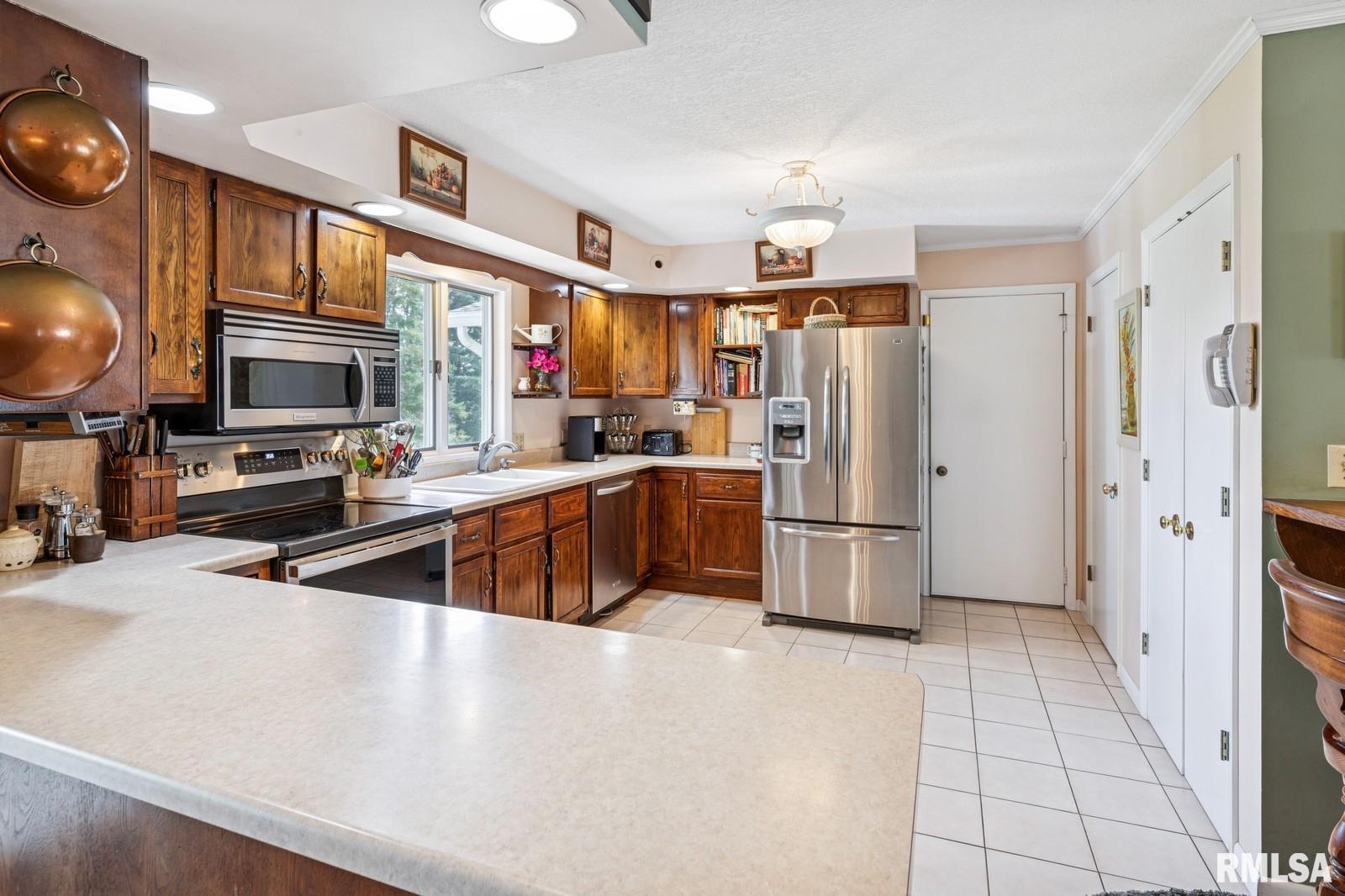 1825 5th Avenue South Clinton, IA 52732 - Photo 8 of 34 a kitchen with stainless steel appliances a refrigerator and a sink