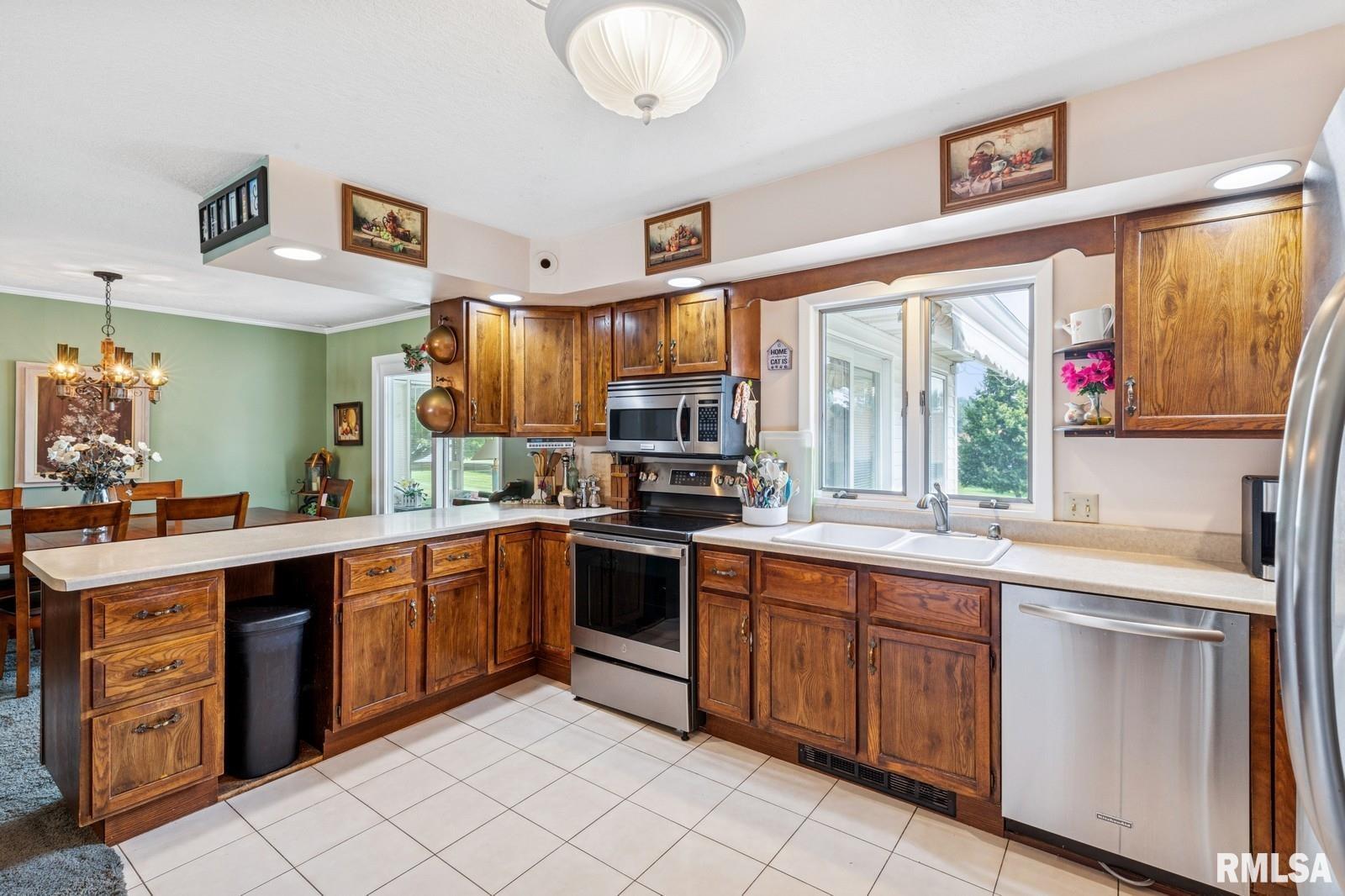 1825 5th Avenue South Clinton, IA 52732 - Photo 9 of 34 a kitchen with stainless steel appliances granite countertop a sink and cabinets
