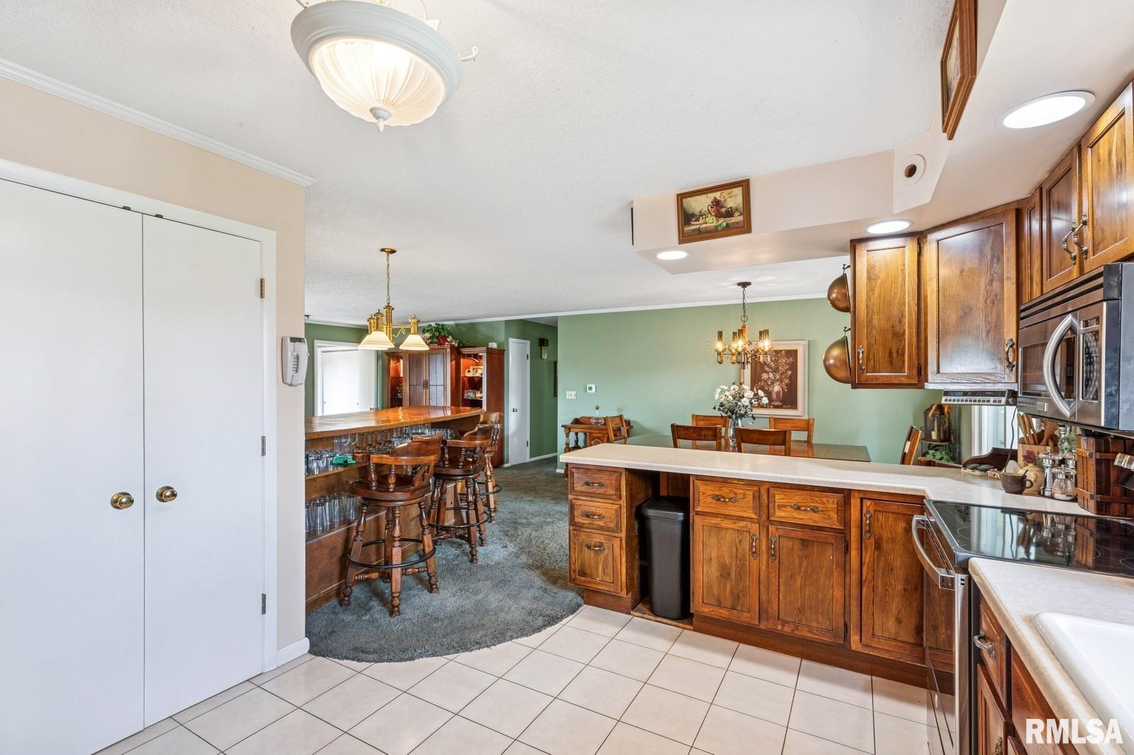 1825 5th Avenue South Clinton, IA 52732 - Photo 10 of 34 a kitchen with stainless steel appliances a sink counter space and cabinets