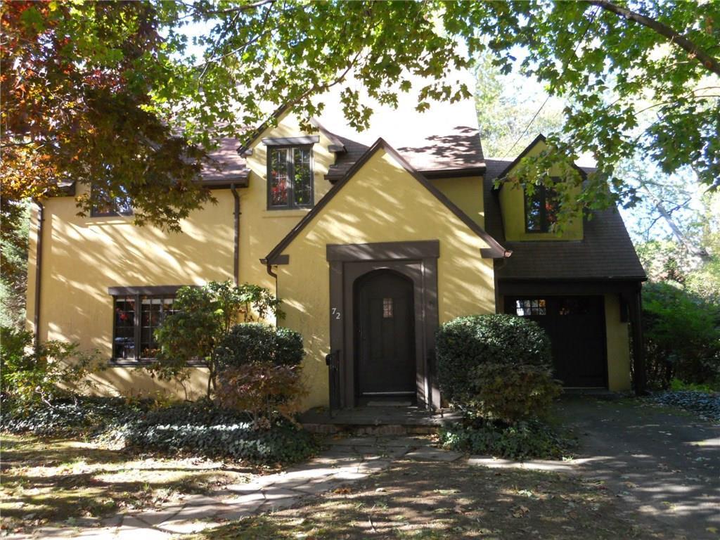 a front view of a house with a yard garage and outdoor seating