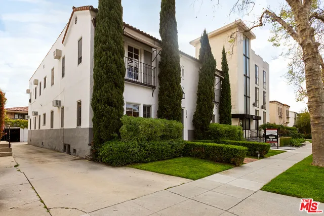 a view of a street with brick building in the background