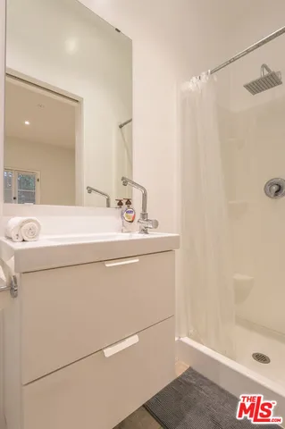 a bathroom with a sink and a shower
