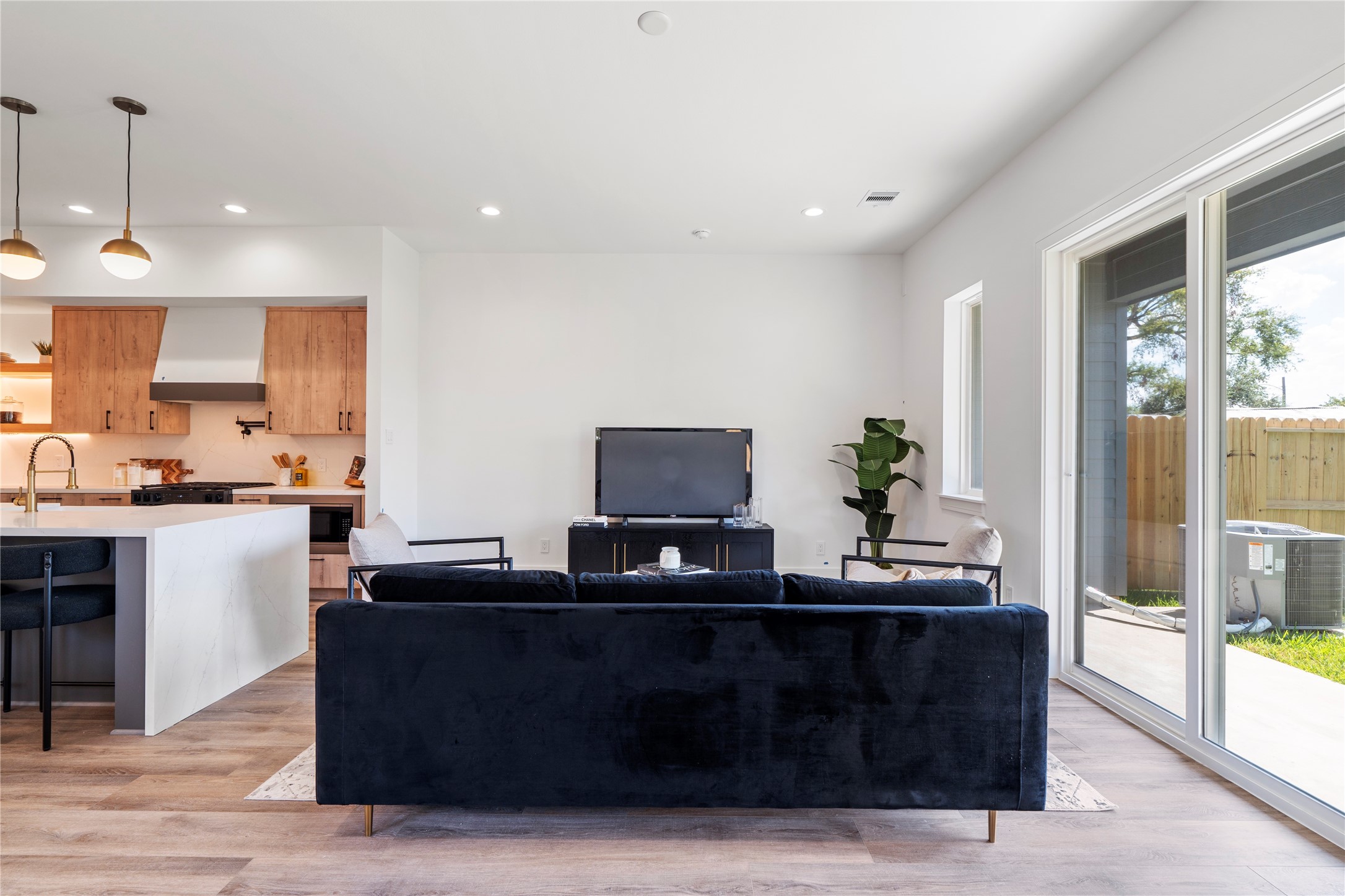 4218 Nichols Street Houston, TX 77020 - Photo 12 of 45 a living room with stainless steel appliances kitchen island granite countertop a sink and a wooden floor