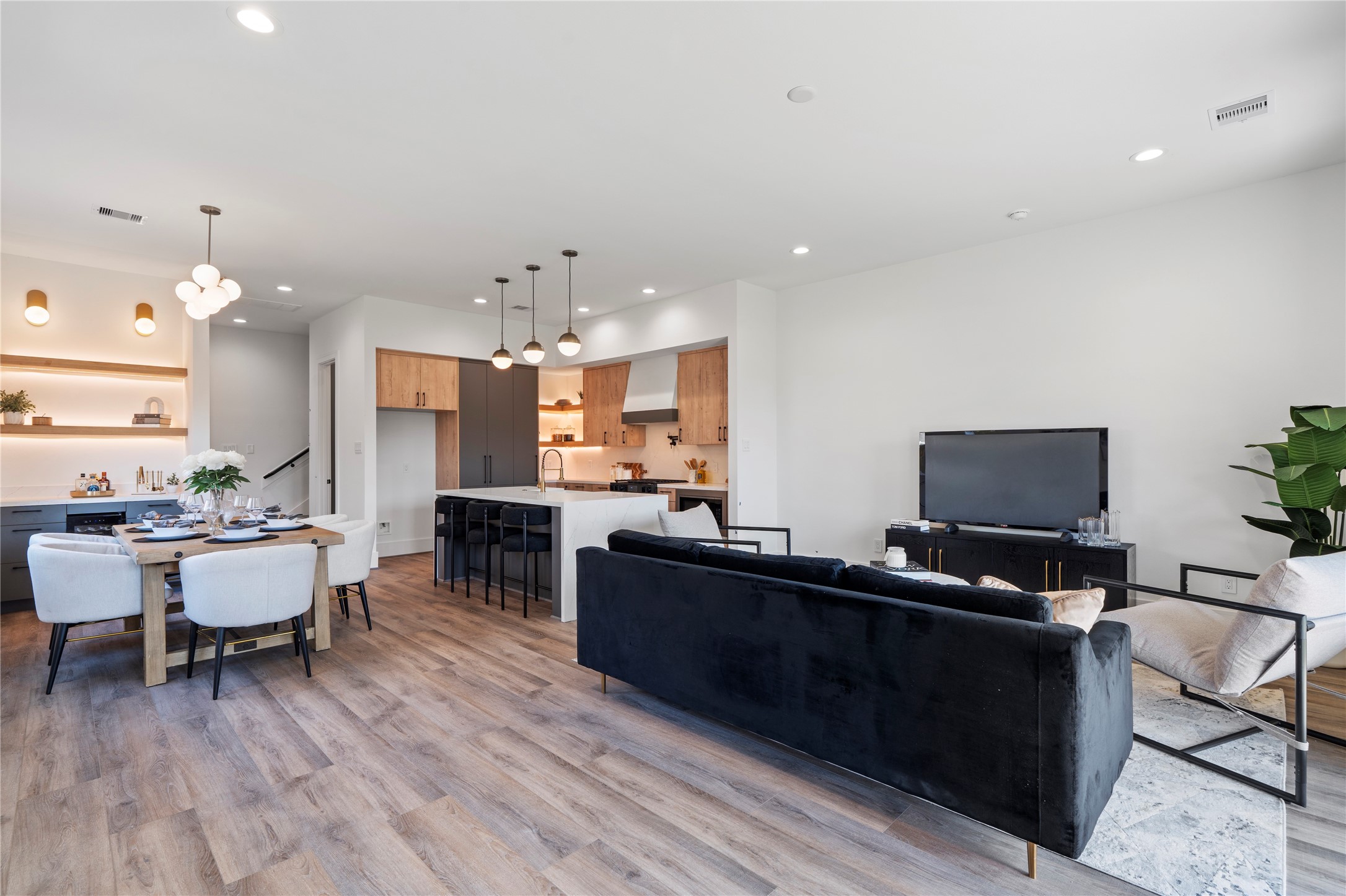 4218 Nichols Street Houston, TX 77020 - Photo 13 of 45 a living room with furniture a flat screen tv and kitchen view