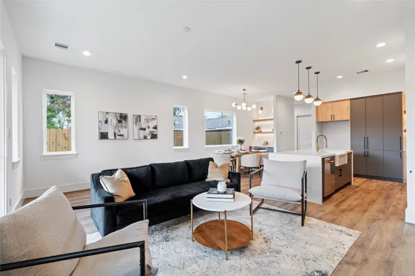 a living room with furniture a rug and a chandelier