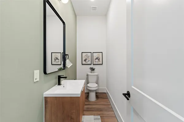 a bathroom with a toilet a sink and mirror