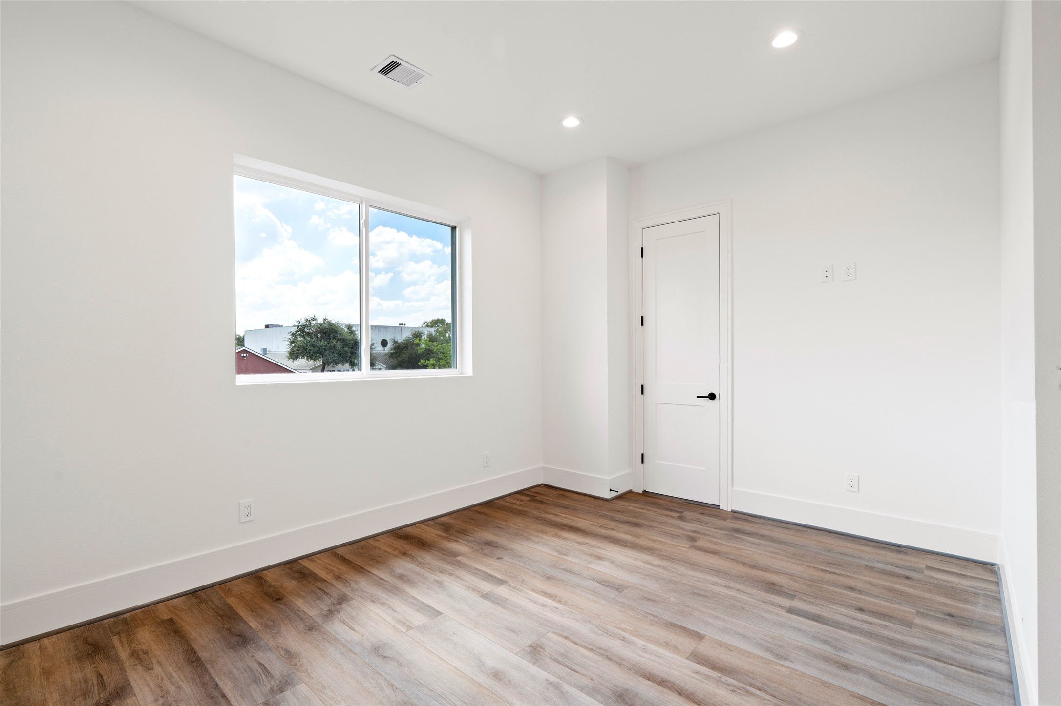 4218 Nichols Street Houston, TX 77020 - Photo 27 of 45 an empty room with wooden floor and windows
