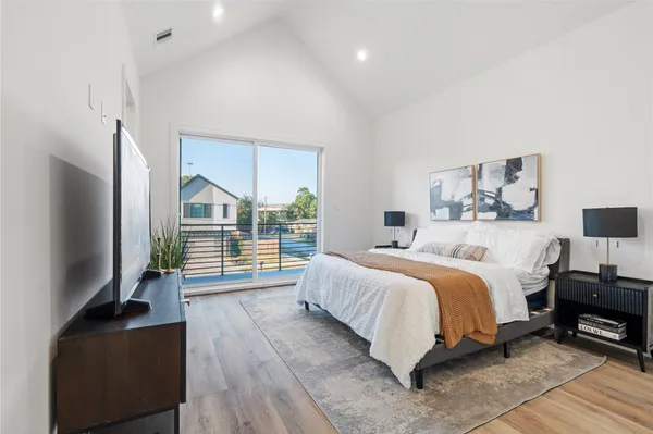 a bedroom with a bed and a flat tv screen