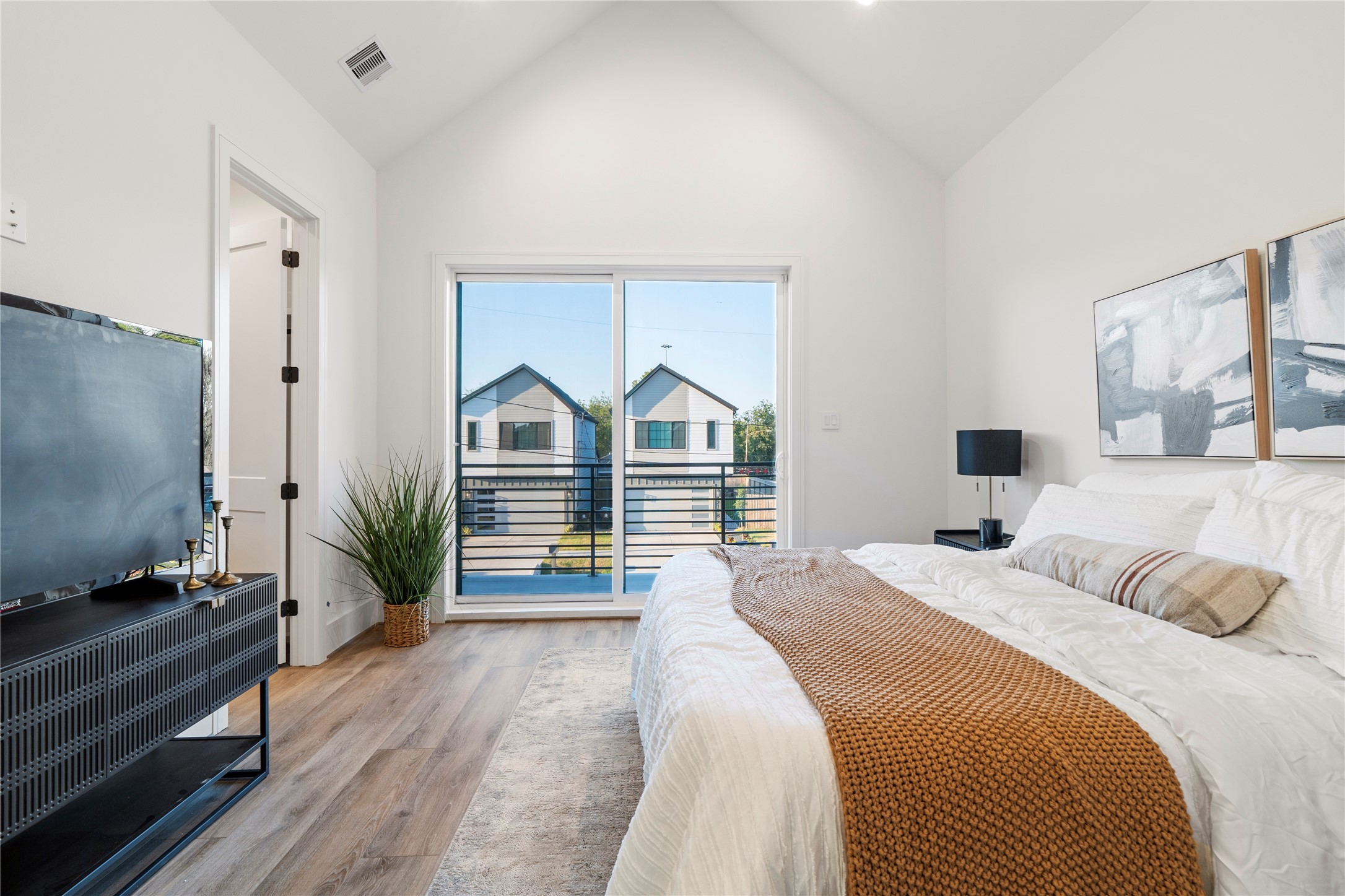 4218 Nichols Street Houston, TX 77020 - Photo 29 of 45 a bedroom with a bed and a flat tv screen on dresser