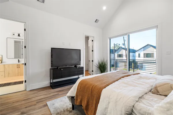 a bedroom with a bed and a flat screen tv