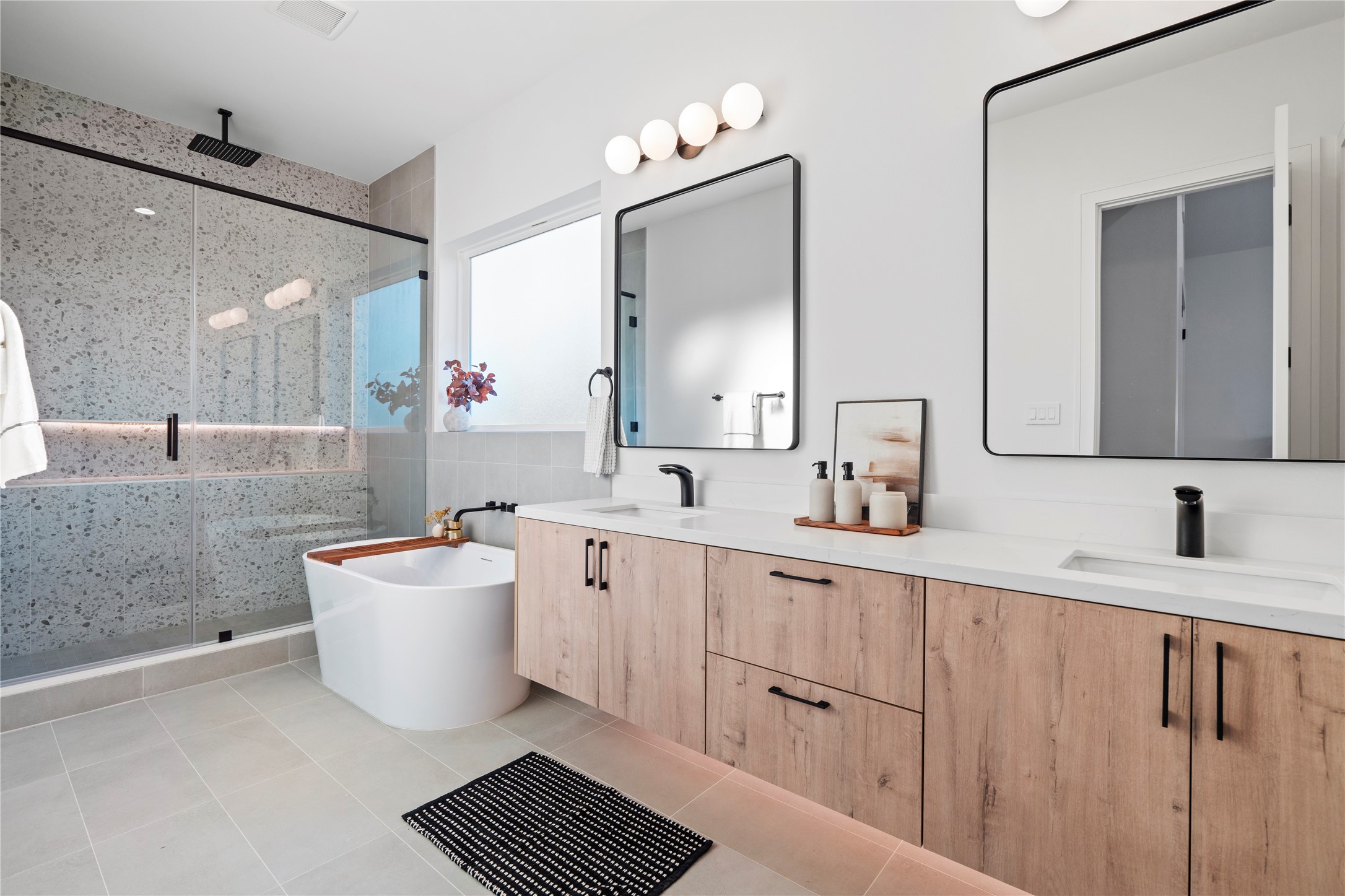 4218 Nichols Street Houston, TX 77020 - Photo 34 of 45 a bathroom with a double vanity sink a mirror and a bathtub