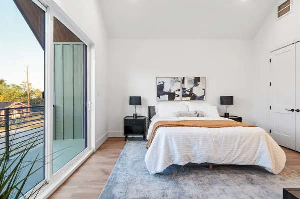 a bedroom with a bed and a large window