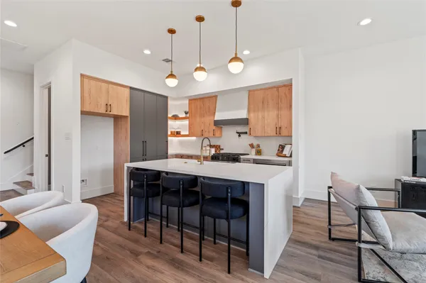 a large kitchen with a table and chairs