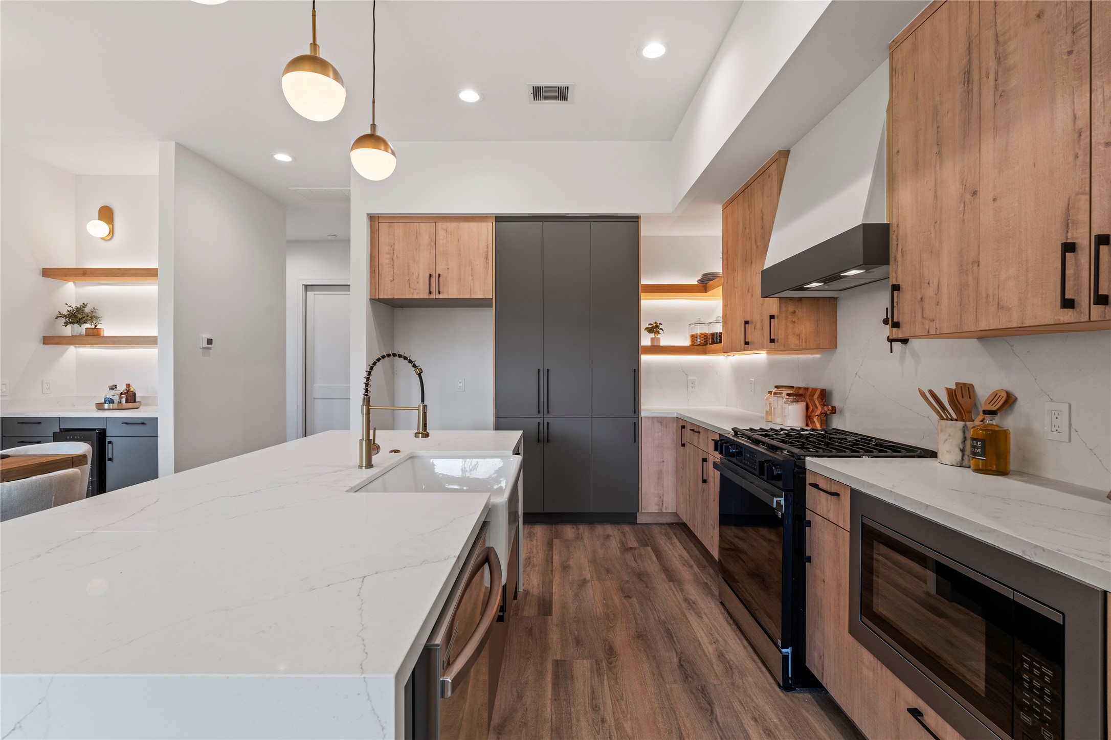 4218 Nichols Street Houston, TX 77020 - Photo 6 of 45 a kitchen with stainless steel appliances granite countertop a stove a sink dishwasher and a refrigerator with wooden floor