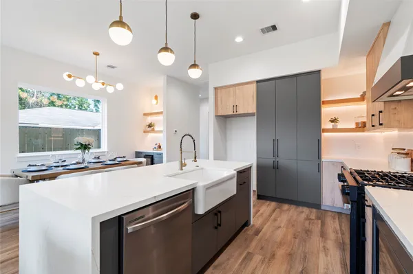a kitchen with stainless steel appliances a sink stove and refrigerator