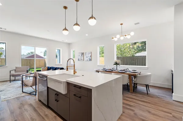 a open kitchen with sink stove and wooden floor
