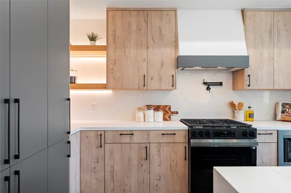 a kitchen with stainless steel appliances a stove a sink and a refrigerator