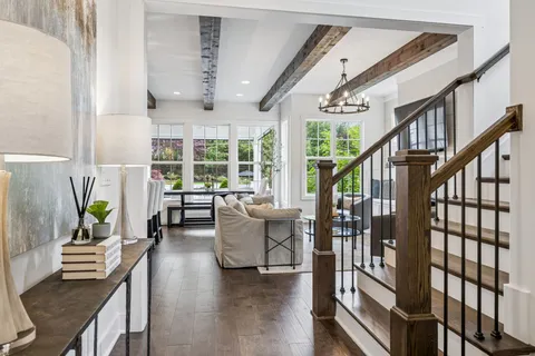 a living room with furniture kitchen and a chandelier