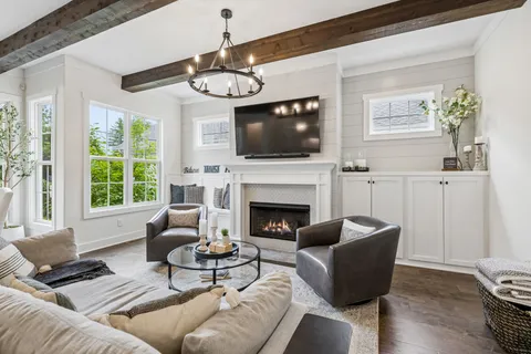 a kitchen with stainless steel appliances granite countertop a table chairs stove and white cabinets