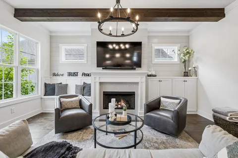 a kitchen with granite countertop a sink stainless steel appliances and white cabinets