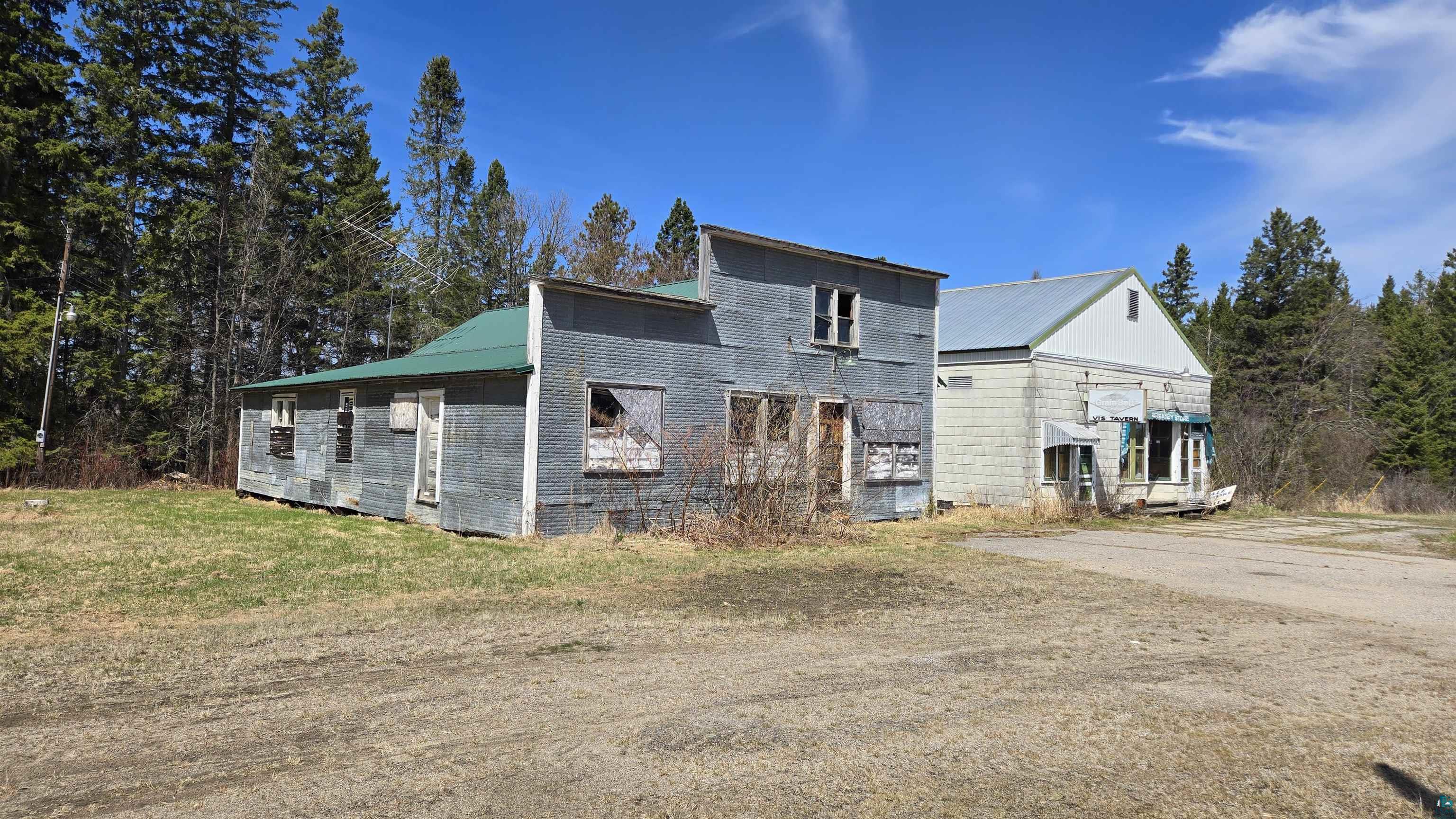 3293 South Greaney Road Orr, MN 55771 - Photo 6 of 17 Two structures with a backdrop of mature pine trees
