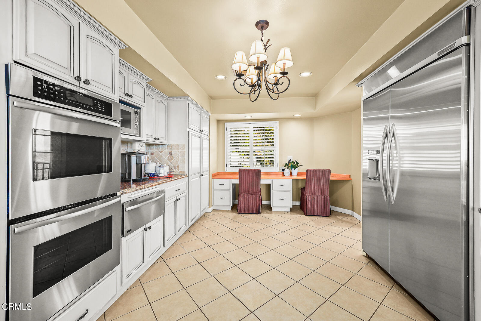 Undisclosed Address Burbank, CA 91501 - Photo 14 of 70 a kitchen with stainless steel appliances granite countertop a refrigerator oven a sink dishwasher and white cabinets with wooden floor