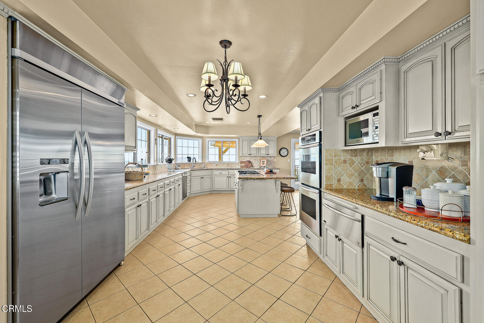 Undisclosed Address Burbank, CA 91501 - Photo 16 of 70 a kitchen with stainless steel appliances granite countertop a refrigerator a sink dishwasher and white cabinets with wooden floor