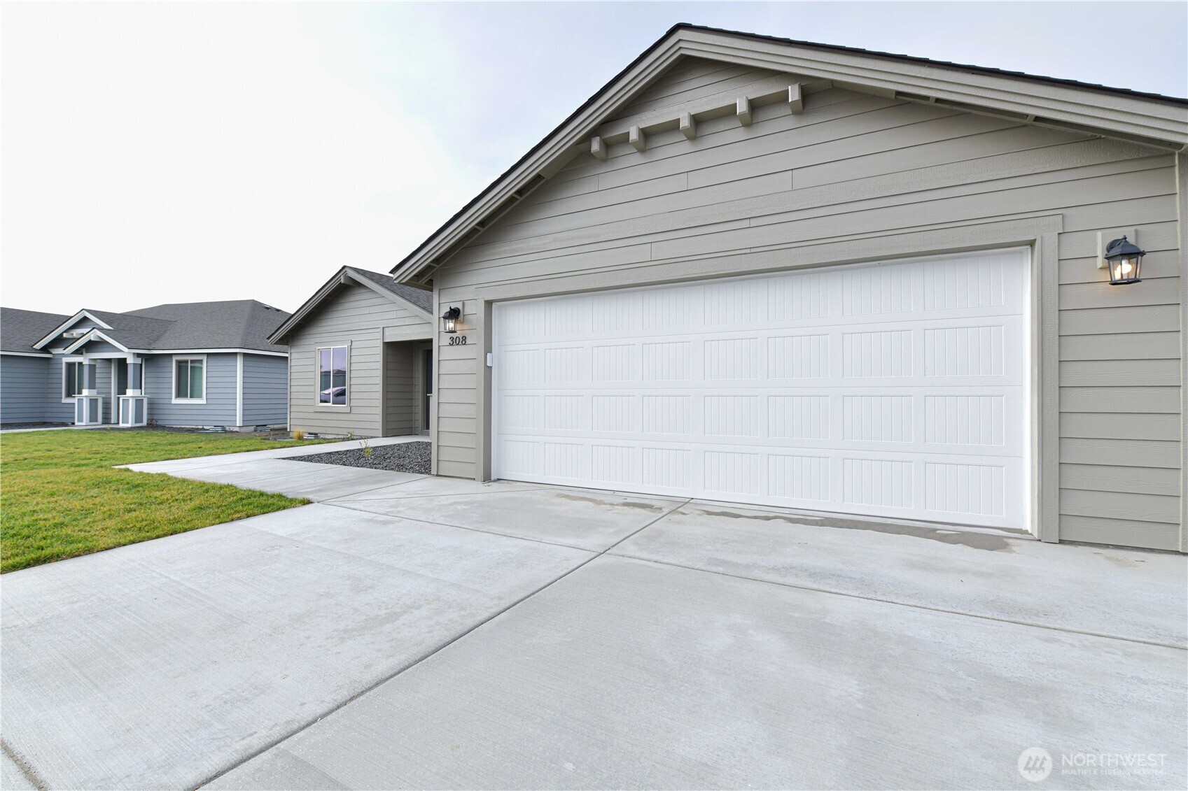 308 North Sandy Loop Moses Lake, WA 98837 - Photo 2 of 18 a front view of house with garage and yard
