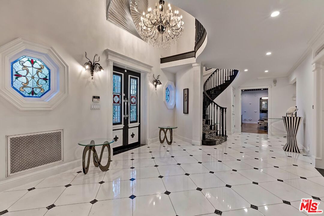 725 North Faring Road Los Angeles, CA 90077 - Photo 12 of 56 a view of a hallway with dining area and chandelier