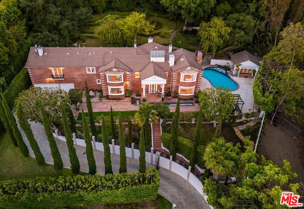 725 North Faring Road Los Angeles, CA 90077 - Photo 2 of 56 an aerial view of a house with a garden and lake view