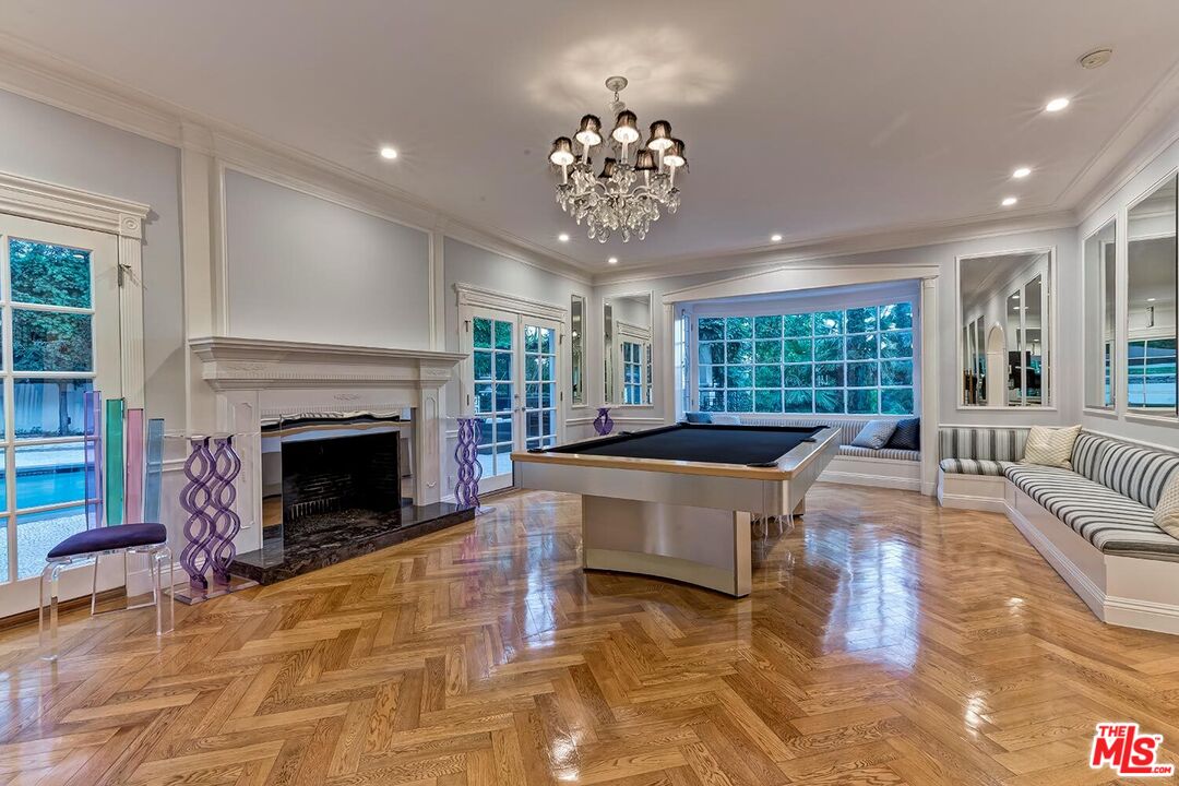 725 North Faring Road Los Angeles, CA 90077 - Photo 24 of 56 a living room with furniture a large window and a fireplace