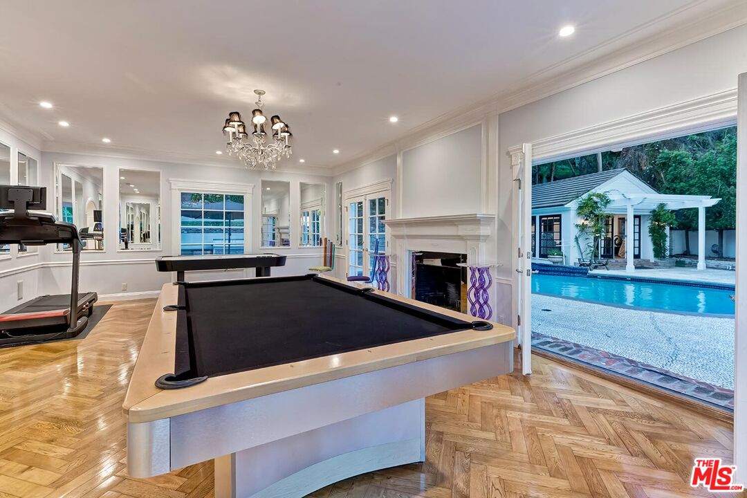 725 North Faring Road Los Angeles, CA 90077 - Photo 25 of 56 a living room with furniture and a fireplace