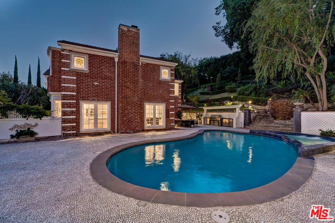 725 North Faring Road Los Angeles, CA 90077 - Photo 27 of 56 a view of a swimming pool with a patio
