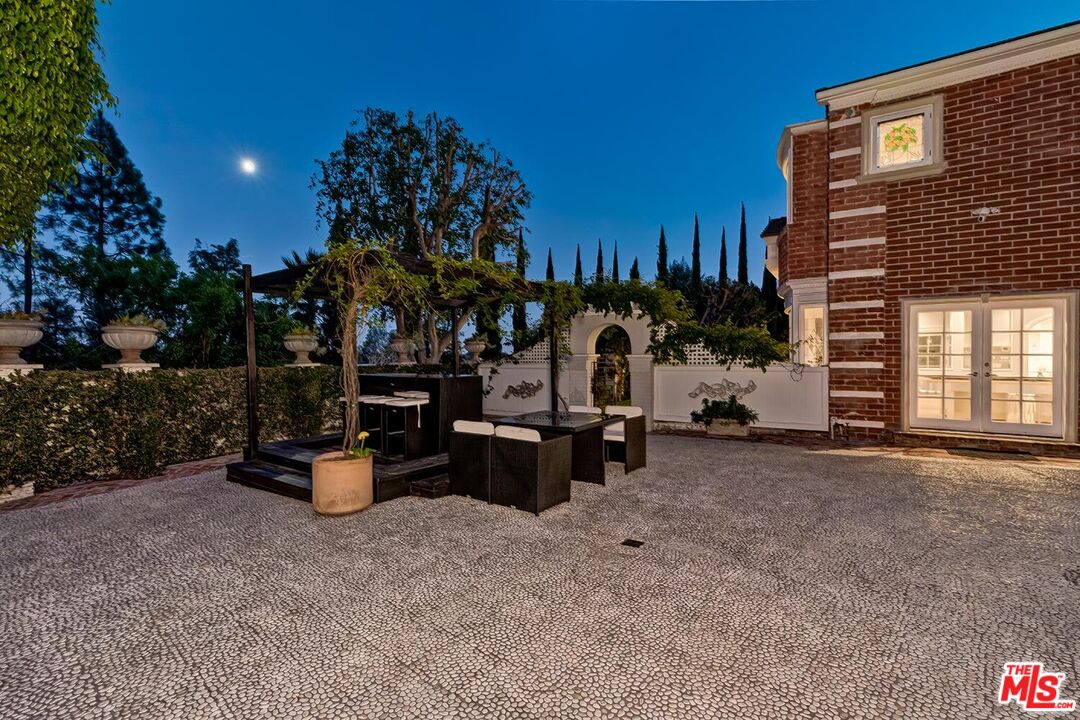 725 North Faring Road Los Angeles, CA 90077 - Photo 30 of 56 a view of a house with backyard and sitting area