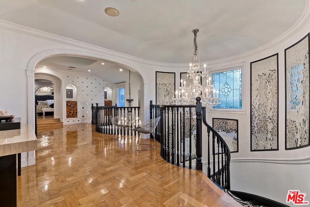 725 North Faring Road Los Angeles, CA 90077 - Photo 33 of 56 a view of a hallway with dining area chandelier