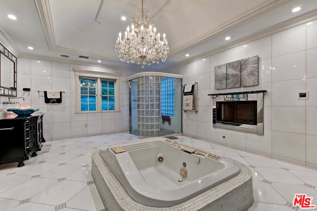 725 North Faring Road Los Angeles, CA 90077 - Photo 39 of 56 a spacious bathroom with a large tub shower and sink