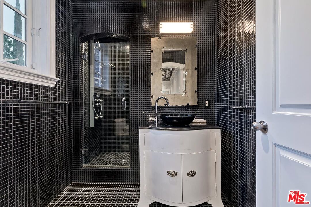 725 North Faring Road Los Angeles, CA 90077 - Photo 42 of 56 a bathroom with a sink and a mirror