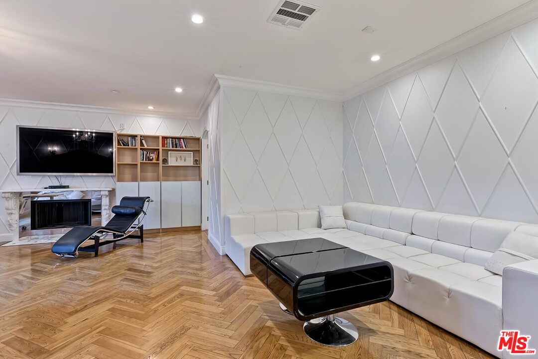 725 North Faring Road Los Angeles, CA 90077 - Photo 44 of 56 a living room with furniture and a flat screen tv
