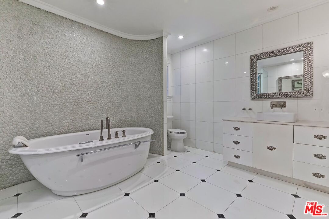 725 North Faring Road Los Angeles, CA 90077 - Photo 46 of 56 a bathroom with a sink and mirror