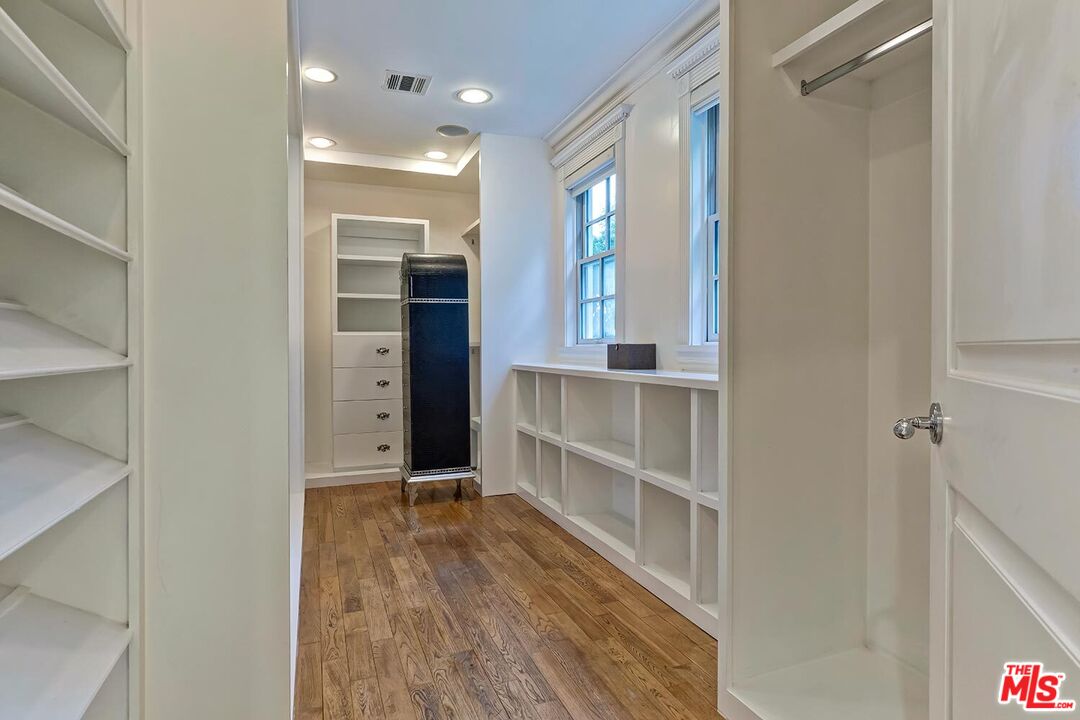 725 North Faring Road Los Angeles, CA 90077 - Photo 47 of 56 a view of an empty room with wooden floor and a window