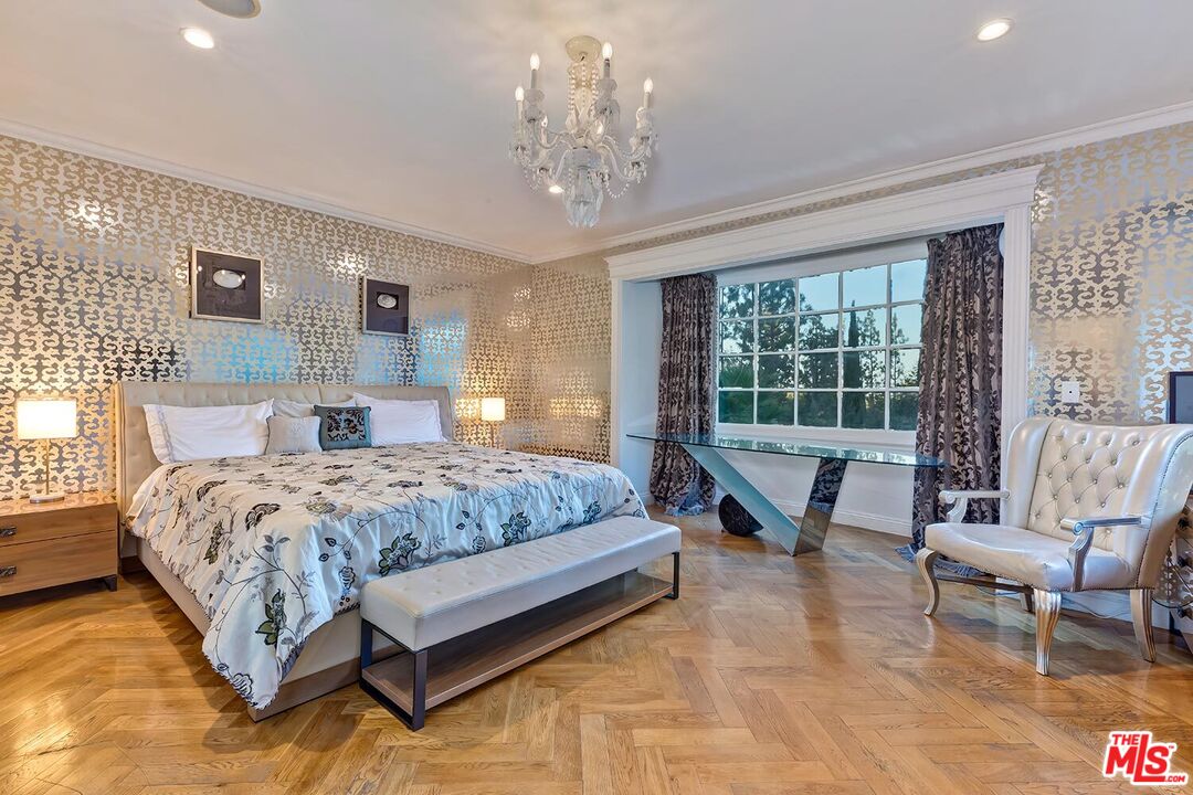725 North Faring Road Los Angeles, CA 90077 - Photo 48 of 56 a spacious bedroom with a bed a table and chair
