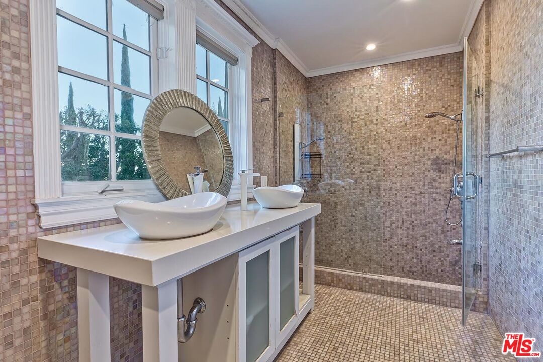725 North Faring Road Los Angeles, CA 90077 - Photo 49 of 56 a bathroom with a sink and a mirror