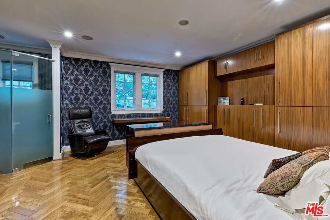 725 North Faring Road Los Angeles, CA 90077 - Photo 50 of 56 a bedroom with a bed and a large window