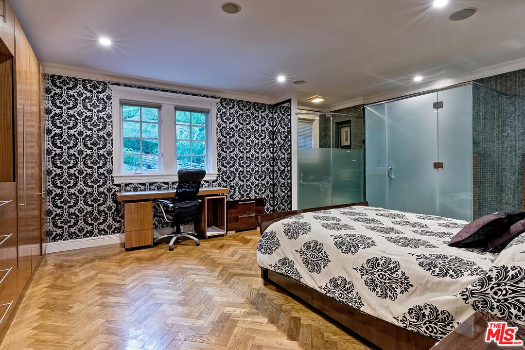 725 North Faring Road Los Angeles, CA 90077 - Photo 52 of 56 a bedroom with a bed and a table in it