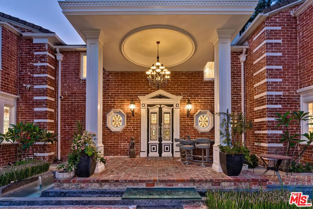 725 North Faring Road Los Angeles, CA 90077 - Photo 6 of 56 a dining room with furniture and a chandelier