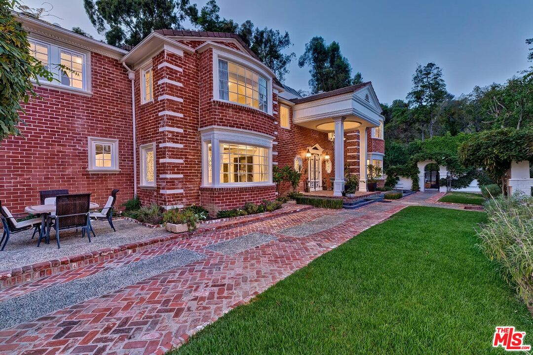 725 North Faring Road Los Angeles, CA 90077 - Photo 8 of 56 a front view of a house with a garden
