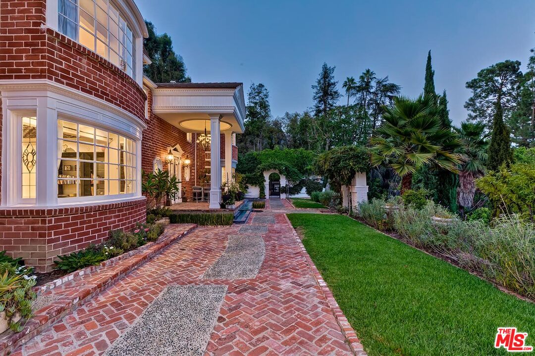 725 North Faring Road Los Angeles, CA 90077 - Photo 9 of 56 a front view of a house with a yard