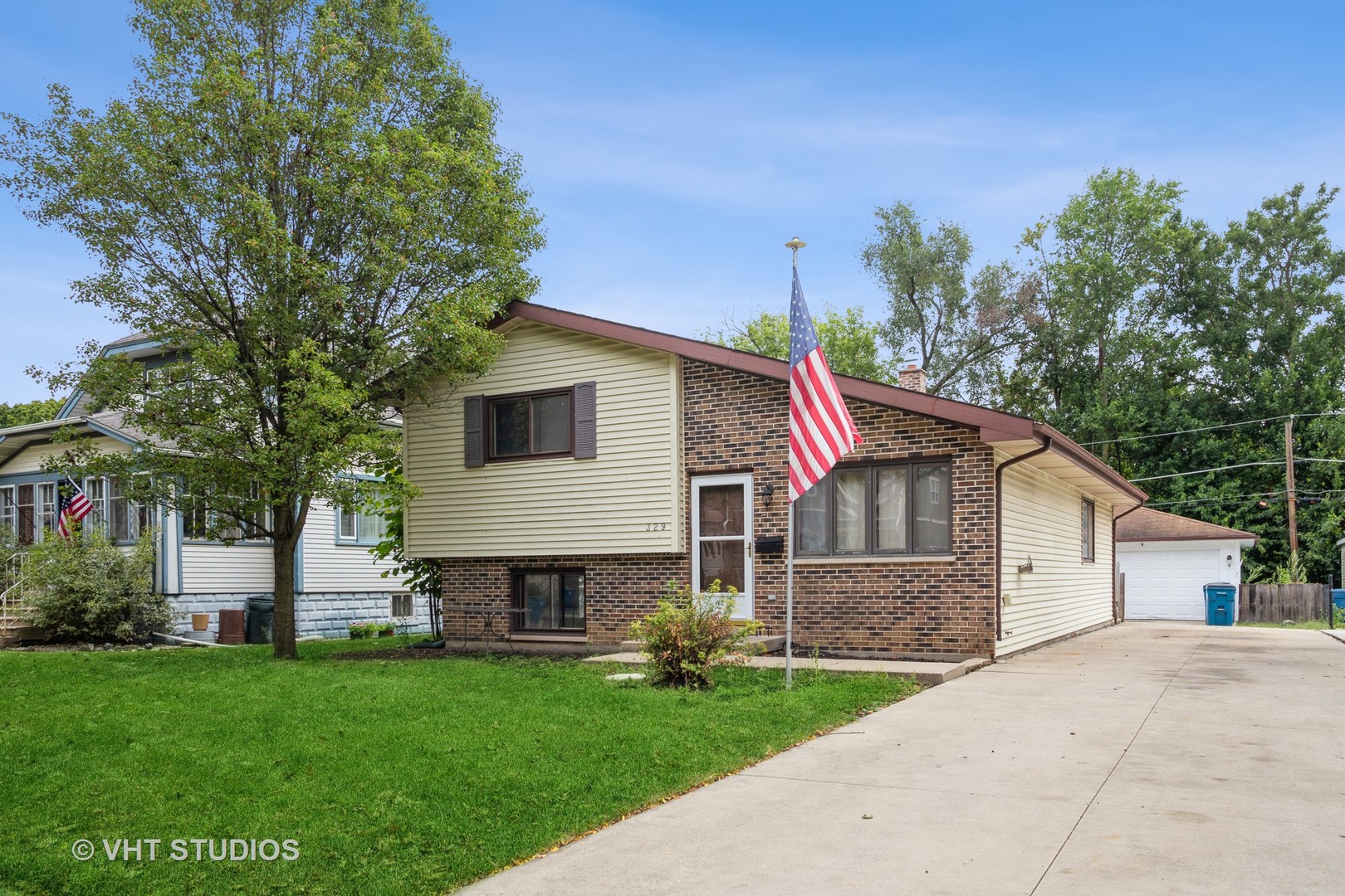 329 South Maple Street Itasca, IL 60143 - Photo 1 of 10 a front view of a house with a garden and trees
