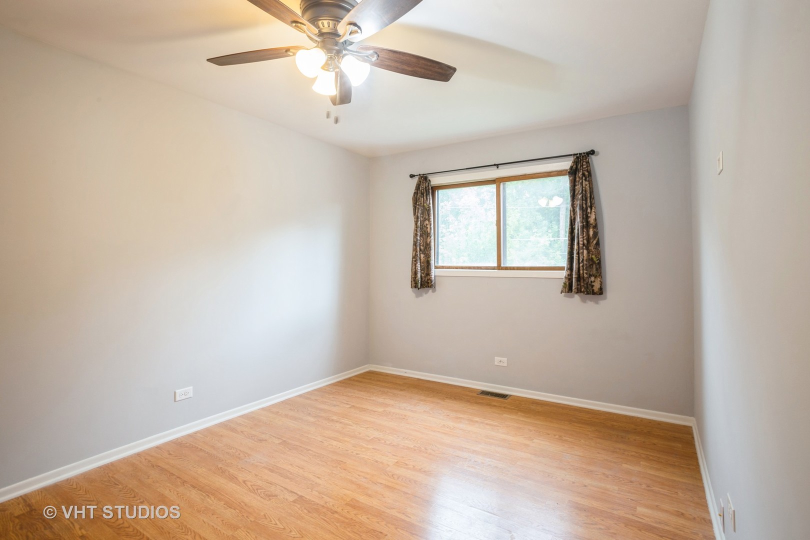 329 South Maple Street Itasca, IL 60143 - Photo 8 of 10 an empty room with a window and a fan