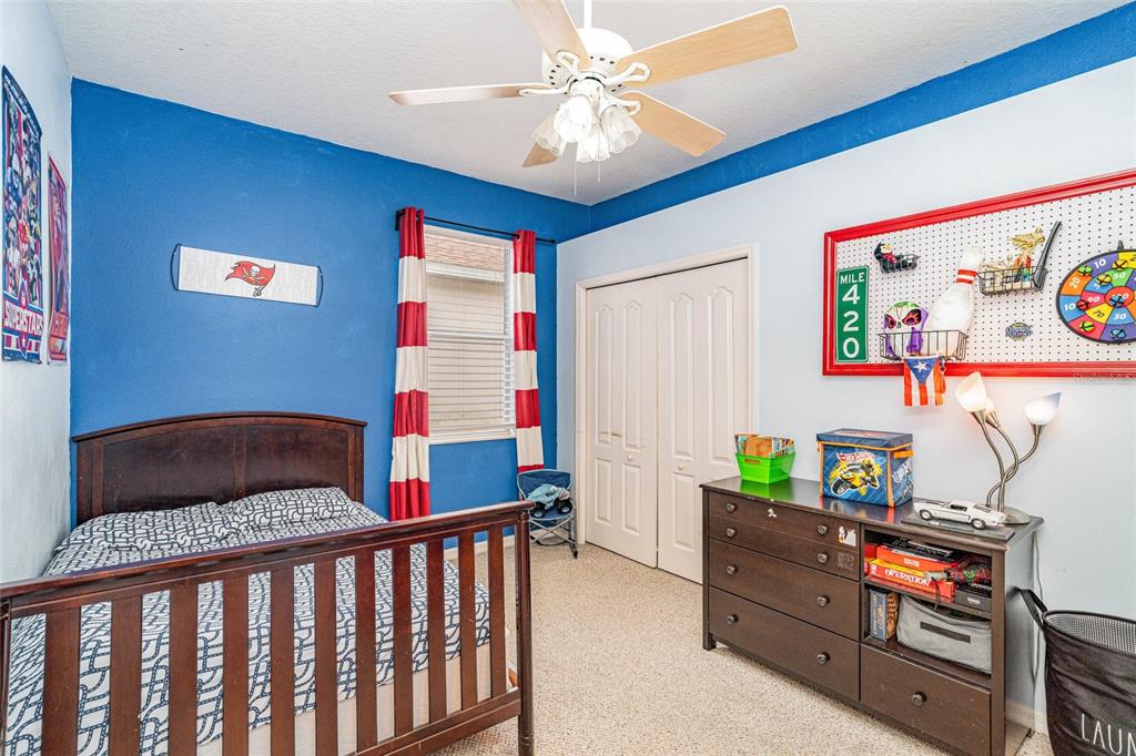 13612 Sigler Street Riverview, FL 33579 - Photo 21 of 31 a bedroom with furniture and a baby crib